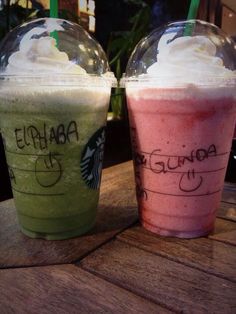 two starbucks drinks sitting next to each other on a table