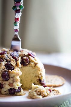 a piece of cake on a plate with a fork sticking out of it and some crackers next to it