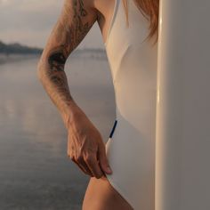 Details Introducing the Boa One Piece - the perfect one piece swimsuit for surfers seeking comfort and style. With its built-in bra, this cleverly designed piece provides exceptional breast support while keeping you fashion-forward. Say goodbye to uncomfortable swimwear and hello to confidence! The Boa One Piece features flattering lines that accentuate your natural curves, making it a timeless and elegant choice for any occasion. Whether you're lounging by the pool or catching waves, this swims Compressive Swimwear With Built-in Bra For Beach, Stretch Swimwear With Built-in Bra For Water Sports, White Second-skin Swimwear For The Beach, White Second-skin Swimwear For Summer, White Tight-fitting Swimwear For Summer, Second-skin Swimwear For Beach Season, Second-skin Beach Swimwear, White Compressive Swimwear For Summer, Compressive Beachwear Bodysuit For Beach