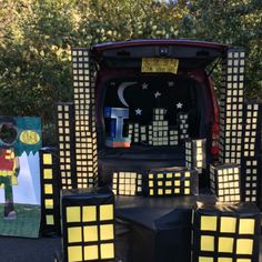 the back end of a vehicle decorated with paper cut outs and cubes on it