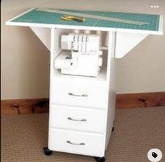 a sewing machine sitting on top of a white table