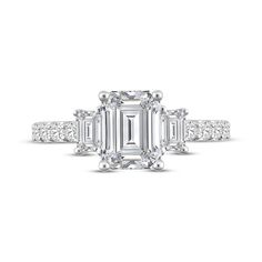 an emerald cut diamond ring with three baguets