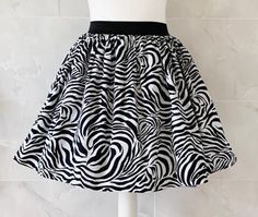 "Zebra print Skirt Gathered full skirt made from a beautiful 100% cotton  fabric. Each skirt is made by gathering the fabric onto  a 2 inch black elastic waistband. The length measures from the top of the waistband and comes in three lengths, 19\", 22\" or 25\". Please choose length from the drop down menu. The waist measurement can be seen in the measurement guide below. Please choose waist size from the drop down menu. The skirt is pictured with a petticoat to show its potential fullness, whic Party Zebra Print Bottoms, Fitted Black Printed Skirt, Nature Skirt, Safari Skirt, Black And White Clothing, Zebra Skirt, Zebra Print Skirt, Fashion Black And White, White Clothing