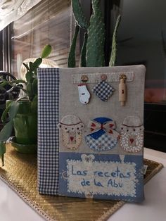 a potted plant sitting on top of a table next to a bag with patches