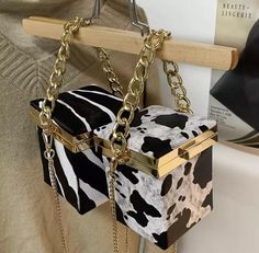 This one of a kind handbag brings additional fierceness & timeless style! We guarantee you’ll fall in love. Animal print is a forever vibe so, be prepared for endless compliments. “ℂ𝕒𝕣𝕣𝕪 𝔸 𝕊𝕥𝕒𝕥𝕖𝕞𝕖𝕟𝕥 ℕ𝕠𝕥 𝕁𝕦𝕤𝕥 𝔸 𝔹𝕒𝕘” Details & Care -Box shaped handbag -Available Prints: Zebra & Cow (black and white) -Pu Leather -Lining: Polyester -Lock latch closure Measurements Size: H 4”x W 5.75” x L 4” Handle Height: 3.9in/ 9.9cm Shoulder Strap Length: 47.2in/ 119.88cm Mini Chain Bag, Mini Box, Pu Bag, Wedding Clutch, Womens Designer Handbags, Printed Handbags, Print Box, Leather Box, Designer Handbag