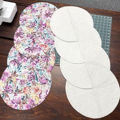 three placemats sitting on top of a wooden table next to a sewing machine