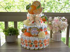 there is a cake made out of oranges and juice cans on top of each other