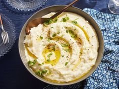 a bowl filled with mashed potatoes topped with olives