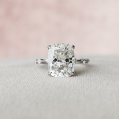 an engagement ring with a cushion cut diamond