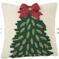 a christmas tree pillow with a bow on it