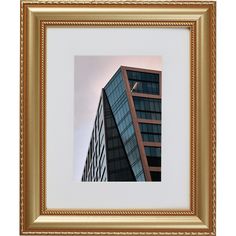 a framed photograph of a tall building with a bird perched on it's roof