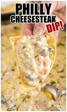 a hand holding up a tortilla chip with cheese and dip in it that says, phily cheesesteak dip