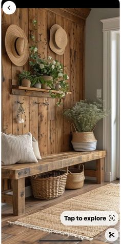 a wooden bench sitting in front of a wall with hats on it and plants growing out of the top