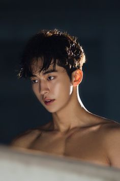 a shirtless young man looking at something in the distance with his eyes closed and no shirt on