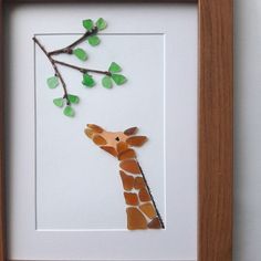 a giraffe is shown in a frame with leaves on the tree branch,