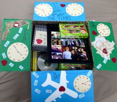 an open box with pictures and clocks on it