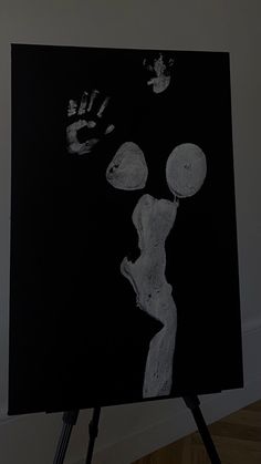 a black and white painting with hand prints on it