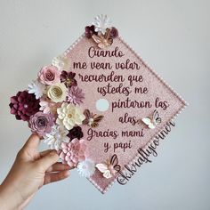 someone is holding up a pink graduation cap with flowers on it and the words canada are written in cursive writing