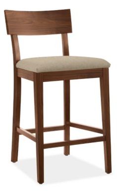 a wooden bar stool with a gray upholstered seat and back cushion on an isolated white background