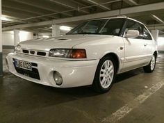 a white car parked in a parking garage