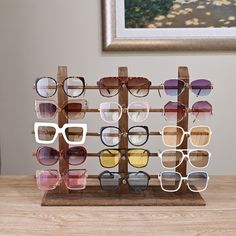 Product Details 15-Pair Sunglasses Display Stand Features SUNGLASS GLASSES DISPLAY RACK: This rustic wooden sunglasses display rack is ideal for storing and showcasing up to 15 eyewear items, such as glasses and jewelry. Display Sunglasses Ideas, Eye Glasses Storage Ideas, Sunglass Storage Ideas, Glasses Storage Ideas, Wooden Glasses Holder, Sunglass Storage, Sunglasses Rack, Sunglass Organizer, Glasses Organizer