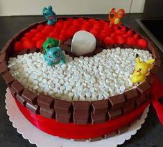 a pokemon themed cake with marshmallows in the middle and other decorations on top