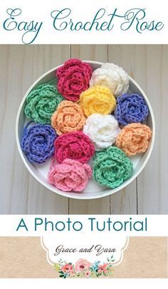 a bowl filled with crochet roses on top of a wooden table