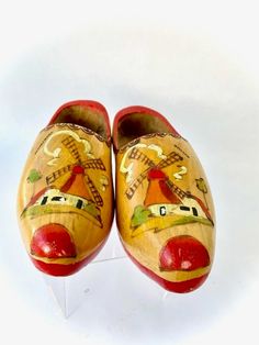 "Vintage Pair of hand painted Children's Dutch Wood Clogs  A sixty year old pair of traditional wooden (clogs) shoes from the Netherlands. I found them during a trip there when it was called Holland. At fifteen years old I became a member of an exceptional local high school band. We traveled to Europe and competed in the 1962 \"World Music Festival\" in Kerkrade, Holland. All band members stayed with Dutch families in the nearby town of Schaesberg. After our performance, the band along with way too many chaperones made our way into the town to shop for souvenirs. None of us had never before seen wooden shoes and we were fascinated. I made sure to bring a pair home and I've had this pair ever since. Printed on shoes: Holland & Schaesberg Dimensions:   8\" long x 2.50\" wide x 3.50\" high $5 Handmade Traditional Closed Toe Clogs, Traditional Handmade Clogs With Round Toe, Traditional Handmade Closed Toe Clogs, Traditional Closed Toe Clogs, Dutch Wooden Shoes, Wood Clogs, Amsterdam Houses, Bicycle Pump, Holland Netherlands