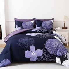 a bed with purple and white flowers on it