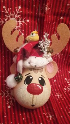 a christmas ornament with a reindeer hat on it's head and nose