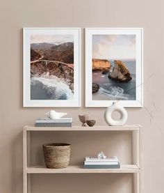 two pictures hanging on the wall next to a shelf with books and vases in front of it