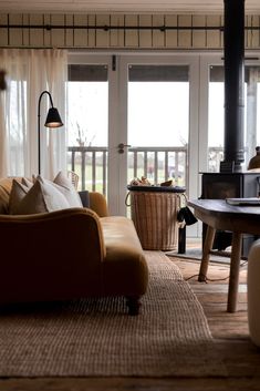 a living room filled with furniture and a fire place in front of a sliding glass door