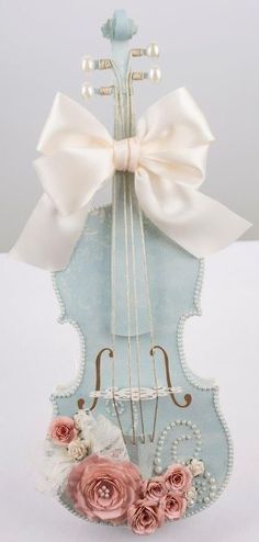 a violin with a bow and flowers on it