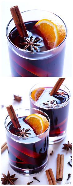 two glasses filled with mulled and cinnamons on top of a white table next to an orange slice