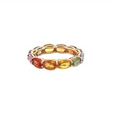 a gold ring with multicolored stones on the inside and outside, set against a white background