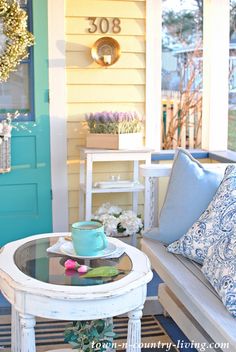 a coffee table sitting on top of a blue and white rug next to a door