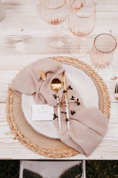 a place setting with silverware and napkins