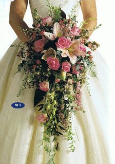 a woman in a wedding dress holding a bouquet