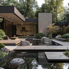 an outdoor area with water, rocks and plants