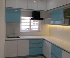 an empty kitchen with blue and white cabinets