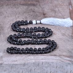 📿Karungali (black ebony wood) is a very powerful tree which our ancestors used. It was used in ancient temples and temple towers (kalasam); was also used in significant homams and other pooja rituals. Ebony Mala is here to remind us to be current and clear-headed so we can make wise and informed decisions. We are being asked to seek new ways to create beauty and harmony that are sustainable for the long-term. This is a time to bring clarity to our intentions as we focus on the future.📿 ✨ MALA Black Spiritual Beaded Necklaces With Polished Beads, Spiritual Black Beaded Necklace With Gemstones, Black 8mm Beads For Gifts, Traditional Black Beads For Meditation, Handmade Black Mala As Gift, Black Polished Beads Necklace For Meditation, Bohemian Black Mala With Round Beads, Black Bohemian Mala With Round Beads, Black Polished Beads Necklace For Healing