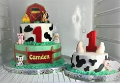 two cakes decorated to look like farm animals are sitting on the shelves in a refrigerator