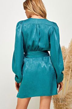 Looking for a dress that will make you feel like a million bucks? Look no further than the Rachael Satin Wrap Style Dress! This show-stopping dress is made from sleek shimmer satin in a beautiful shade of teal. The wrapping bodice with wide sash is so figure-flattering. The long balloon style sleeves, gathered shoulders, and elastic cuffs add a touch of elegance. - Unlined - Dress: 100% Polyester - Fits true to size, contemporary sizing - Hand Wash Cold. Do Not Bleach. Hang Dry. - Imported Postpartum Dress, Teal Satin Dress, Postpartum Dresses, Turquoise Mini Dress, Sorority Recruitment Outfits, Fall Blue, Recruitment Outfits, Shower Dress, Breastfeeding Dress