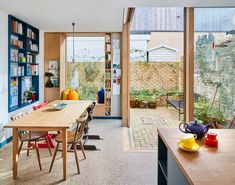 an open kitchen and dining room area with sliding glass doors leading to the back yard