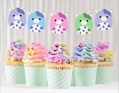 cupcakes with colorful frosting and animal decorations