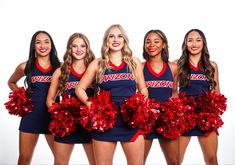 a group of women in cheerleader outfits posing for a photo