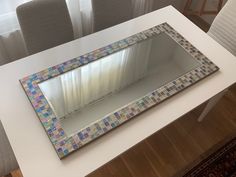 a mirror sitting on top of a white table