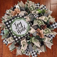 a christmas wreath with the words joy to the world written in black and white on it