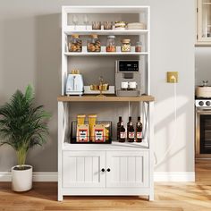 a kitchen with white cabinets and shelves filled with food