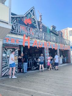 people are standing in front of the entrance to an amusement park that is decorated for halloween